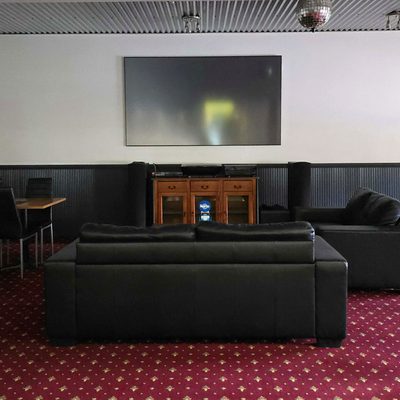 Guest lounge with big screen TV at The Top Pub Rosebery